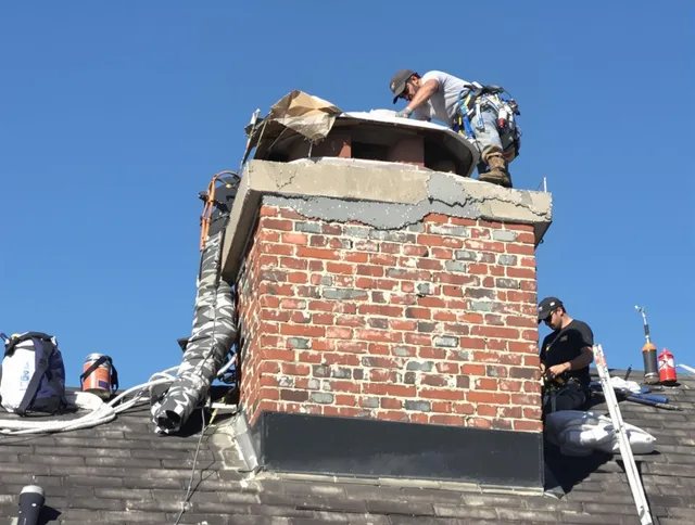 Valley Falls Chimney Sweep installing a custom chimney crown in Valley Falls, RI