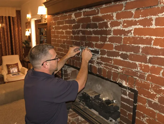 Valley Falls Chimney Sweep expert fixing a fireplace in Valley Falls, RI